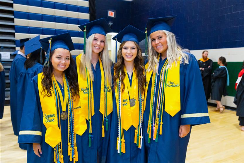 Students wearing blue graduation robes